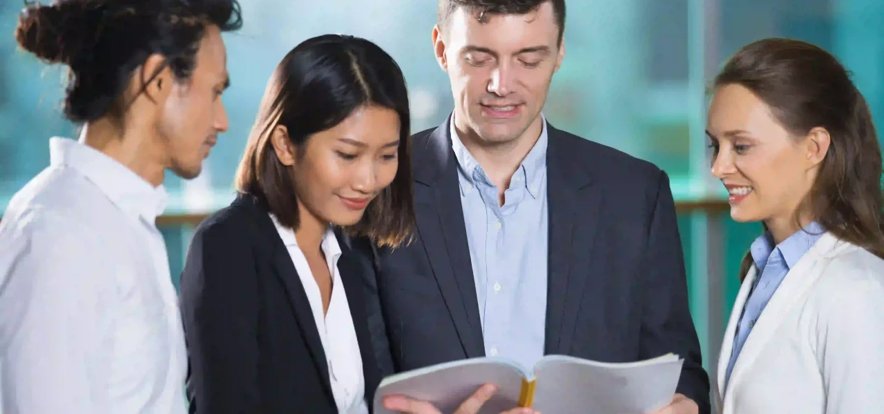 relaxed-business-people-reading-book-together